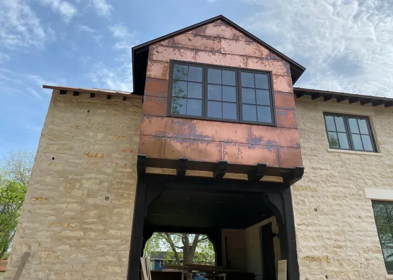 Copper metal panel facade on a stone building for Skylight Installation in Darien