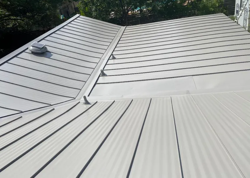 Solar attic fan installed on a metal roof for Roof Ventilation in Darien